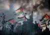 فلسطينيون يرفعون علم فلسطين في غزة مع شارة النصر.jpg