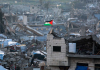 رفع علم فلسطين فوق أنقاض غزة.png