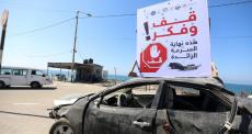 مركبة بعد حادث سير مع لوحة تحذيرية في قطاع غزة