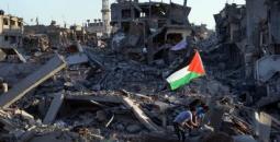 رفع علم فلسطين على أنقاض منازل مدمرة في غزة.jpg