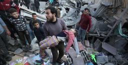 مواطن يحمل طفلته عقب مجزرة إسرائيلية في غزة.jpg