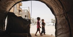 طفلان وسط ملاجئ مؤقتة للنازحين الفلسطينيين في خان يونس.jpg