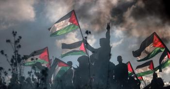 فلسطينيون يرفعون علم فلسطين في غزة مع شارة النصر.jpg