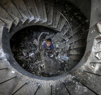 طفل يقف داخل مركز رشاد الشوا بعد تدميره من قبل الاحتلال.jpg