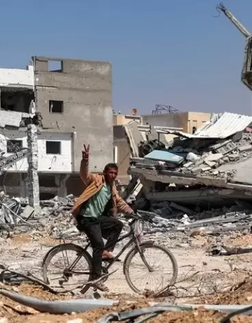 مواطن يرفع شارة النصر في قطاع غزة.webp