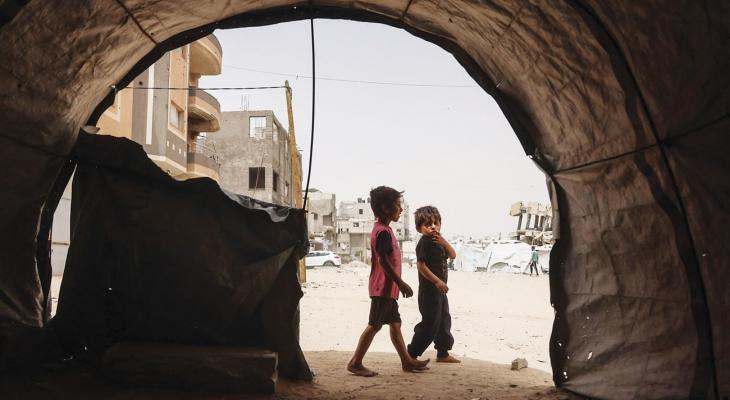 طفلان وسط ملاجئ مؤقتة للنازحين الفلسطينيين في خان يونس.jpg