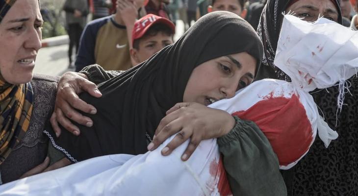 سيدة تودع طفلها الشهيد في غزة.jpeg