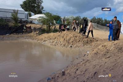 نازحون قرب شاطئ مدينة خان يونس جنوب قطاع غزة يحاولون إصلاح خيامهم التي غمرتها مياه الأمطار4.jpg