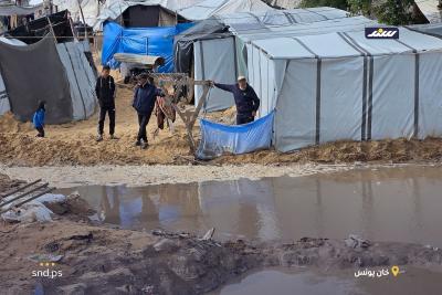 نازحون قرب شاطئ مدينة خان يونس جنوب قطاع غزة يحاولون إصلاح خيامهم التي غمرتها مياه الأمطار1.jpg