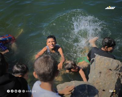 أطفال يقضون أوقاتاً على شاطئ بحر مدينة غزة خلال يوم حار2.jpg